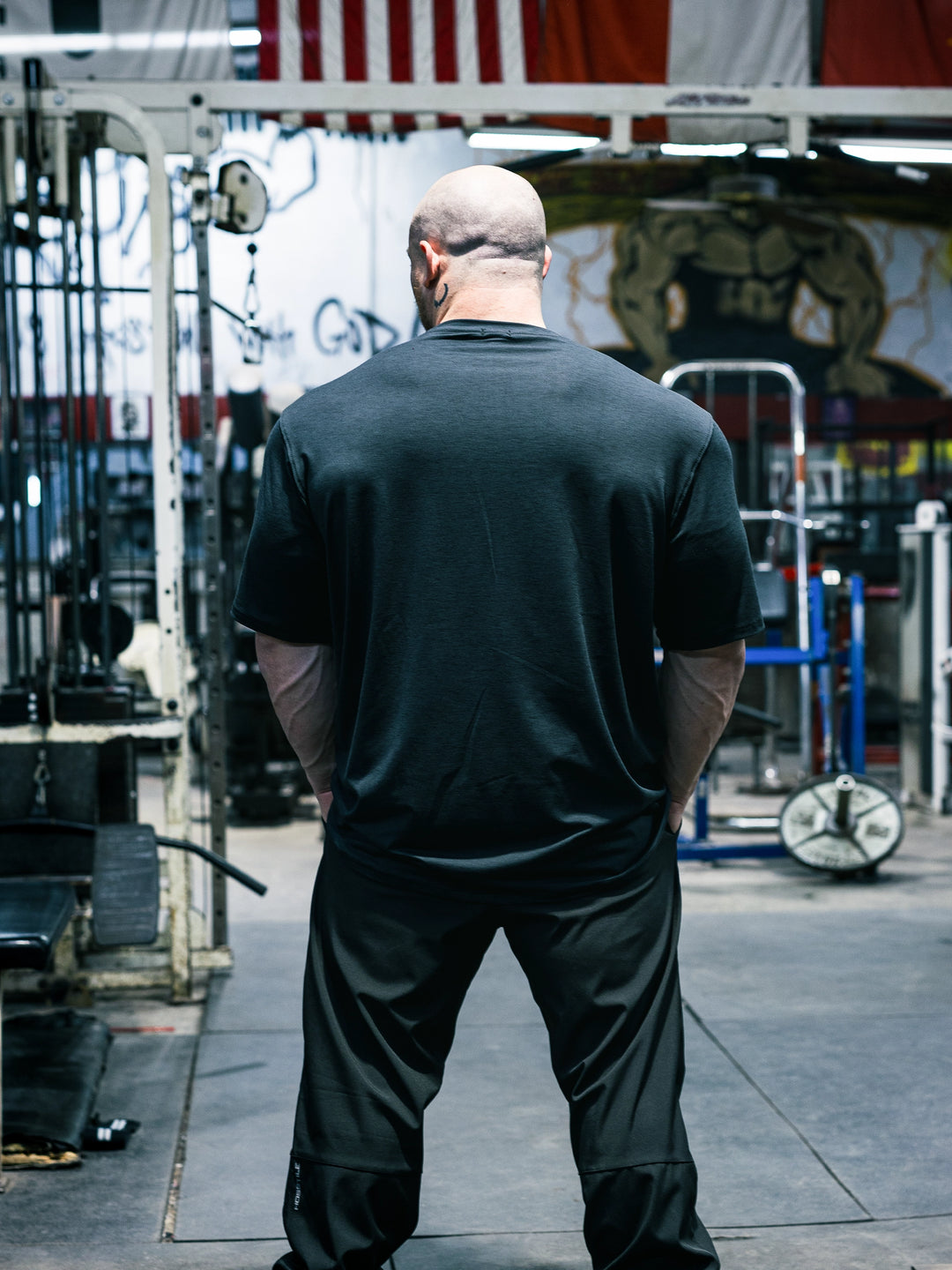 Bodybuilder Martin Fitzwater wearing the Shield Athletic Tee in the gym#color_black