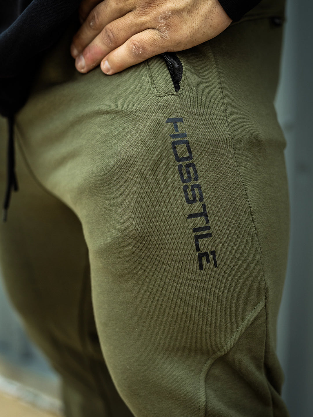 Martin Fitzwater wearing joggers in the gym#color_military-green