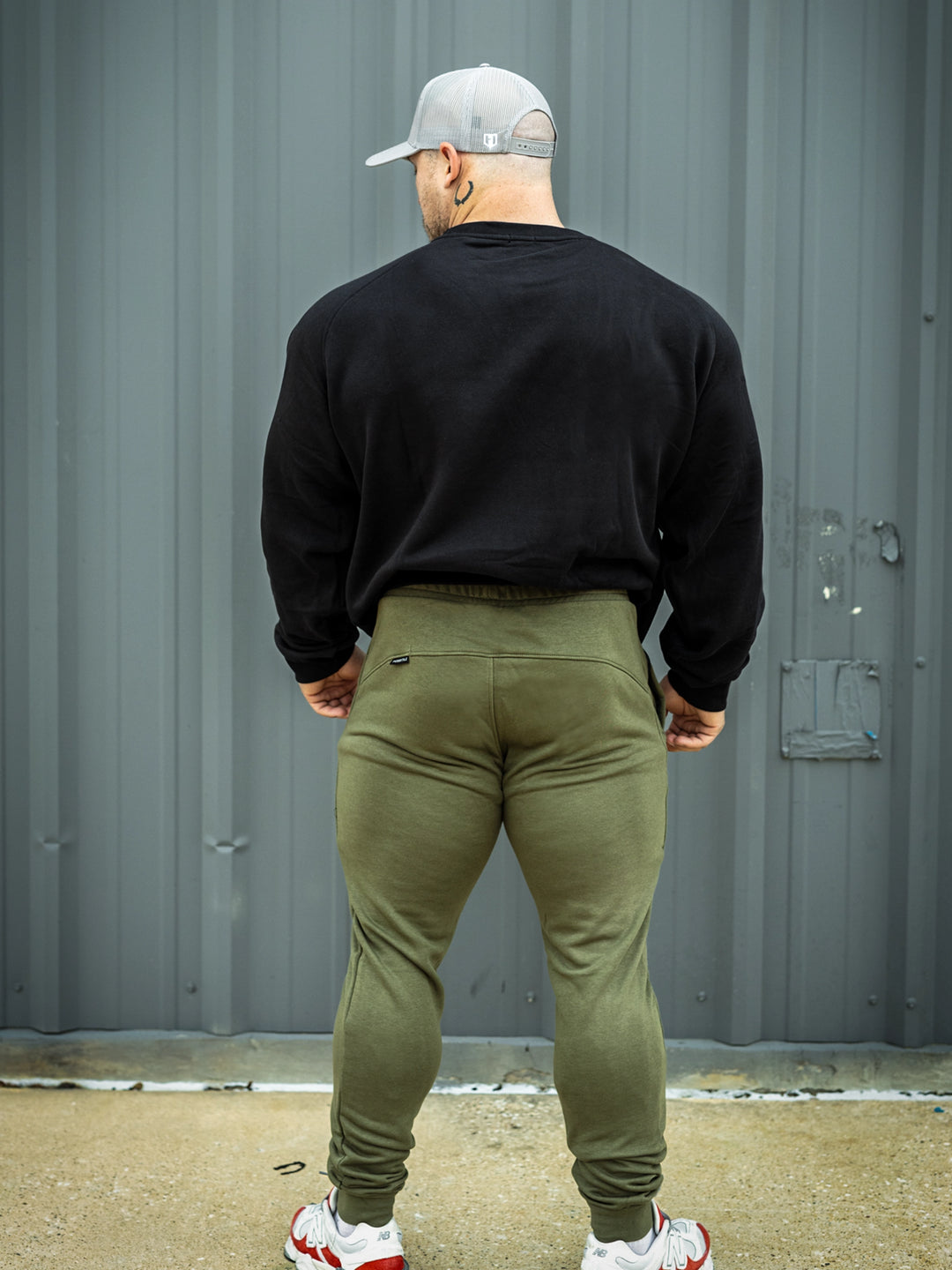 Martin Fitzwater wearing joggers in the gym#color_military-green
