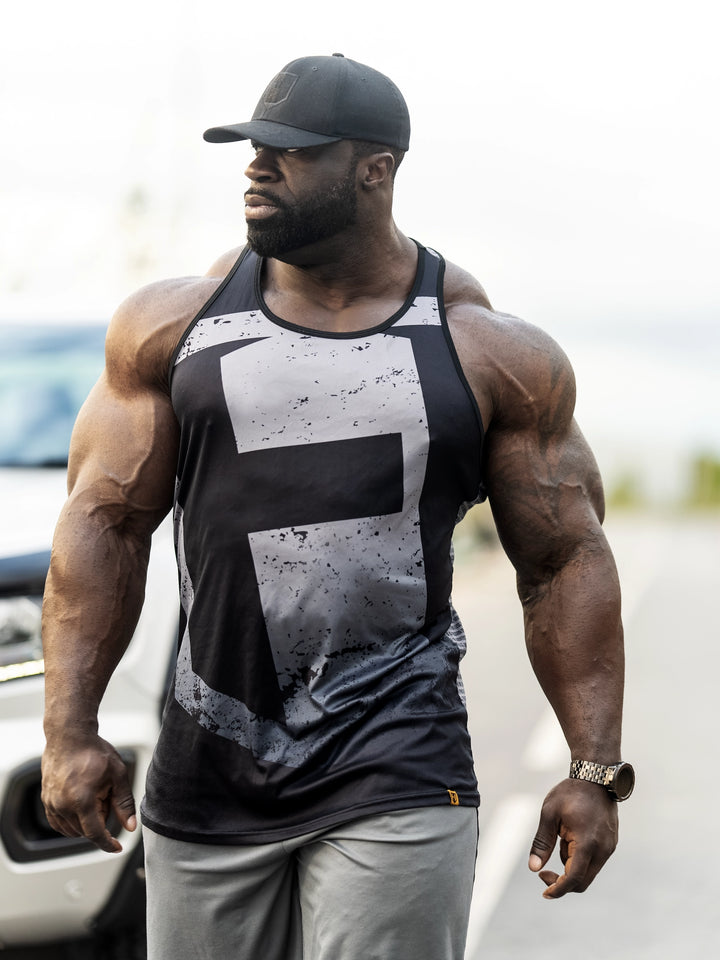 Bodybuilder Samson Dauda wearing the Tagline Long Body Tank Top