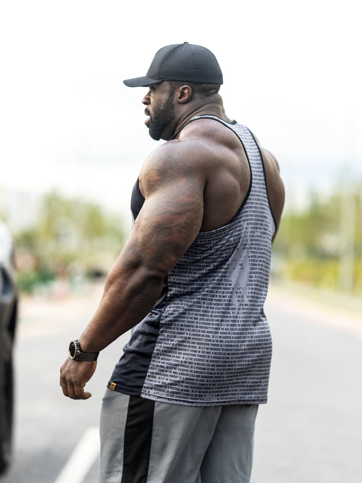 Bodybuilder Samson Dauda wearing the Tagline Long Body Tank Top