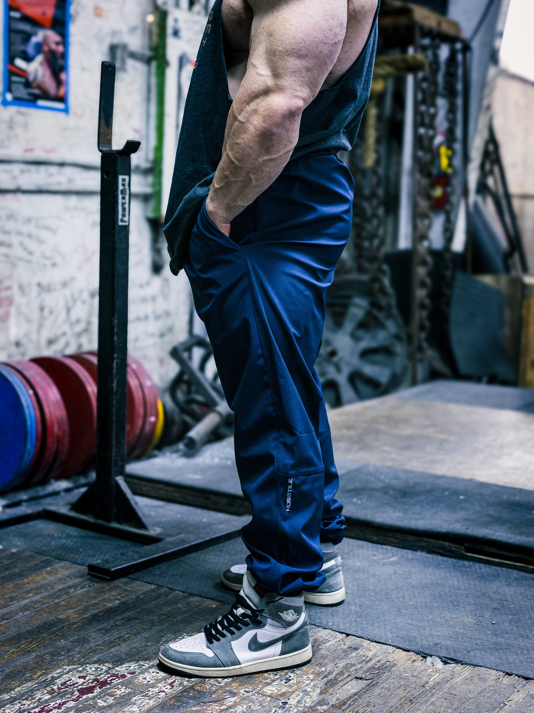 Bodybuilder Martin Fitzwater wearing the Utility Joggers in the gym#color_navy