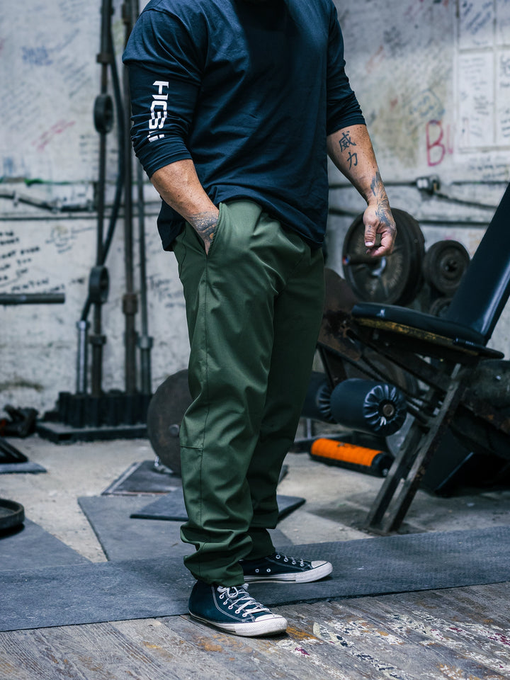 Bodybuilder Ben Chow wearing the Utility Joggers in the gym#color_military-green