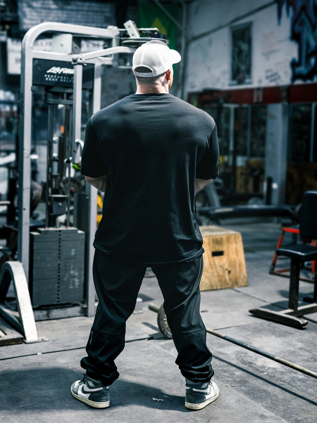 Bodybuilder Martin Fitzwater wearing the Mr. Olympia #19 Samson Dauda t-shirt in the gym#color_black