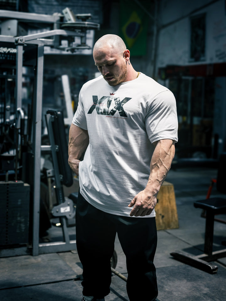 Bodybuilder Martin Fitzwater wearing the Mr. Olympia #19 Samson Dauda t-shirt in the gym#color_white