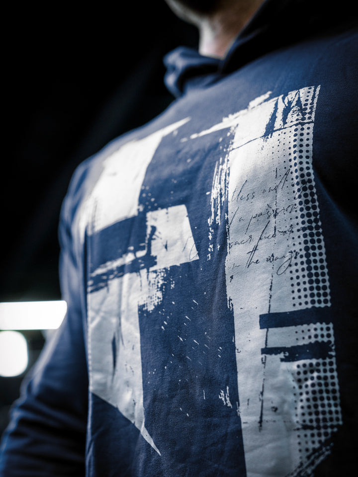 IFBB Pro Bodybuilder Martin Fitzwater wearing a navy hoodie and cap in a gym setting#color_navy