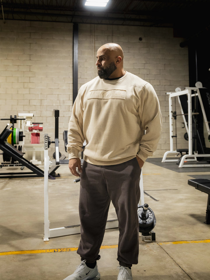 Bodybuilder Fouad Abiad wearing the Raw Crewneck Sweatshirt#color_cement