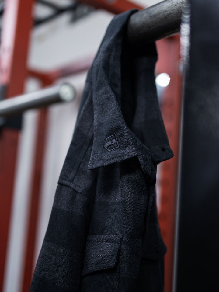 Hosstile Shield Long Sleeve Plaid Flannel Button Down Shirt Model Ben Chow#color_charcoal-black